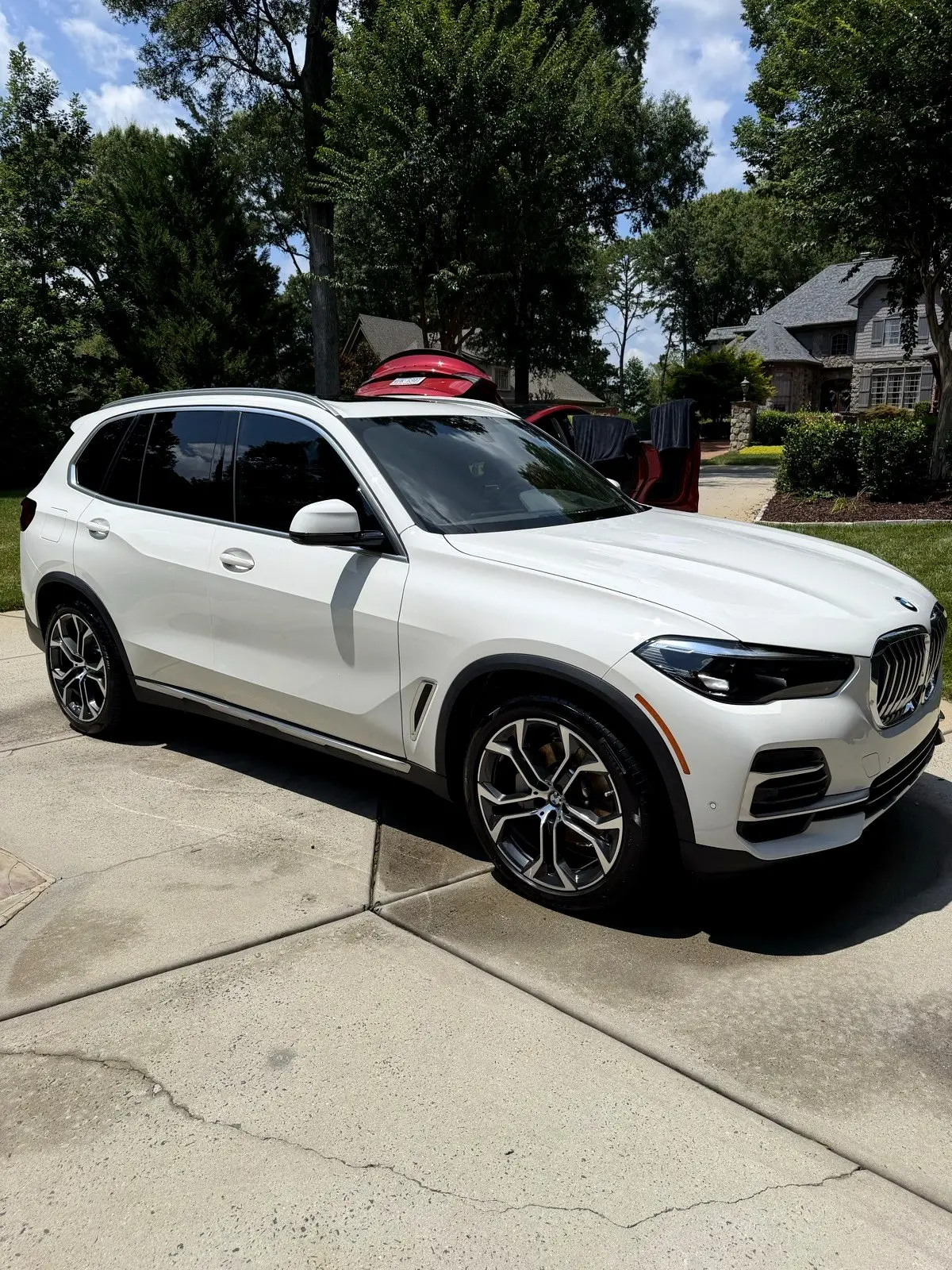 A white SUV freshly washed on a driveway